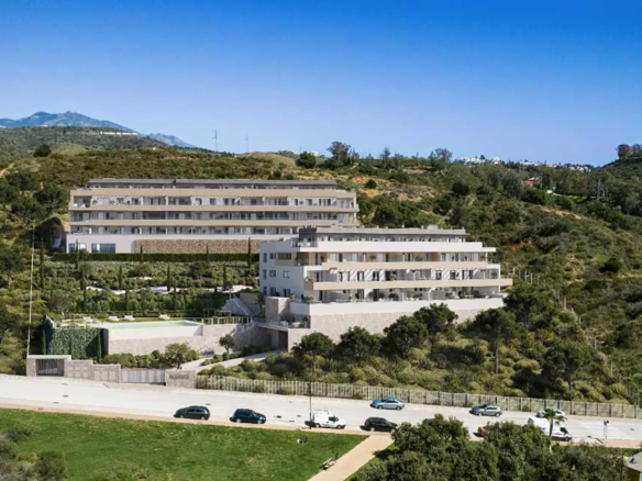 Aerial view of Almare Cala de Mijas residential complex surrounded by nature and sea views