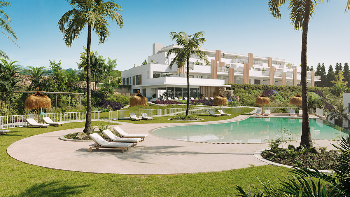 Abril Doña Julia – Casares - luxury pool area with sun loungers, palm trees and modern white residential building