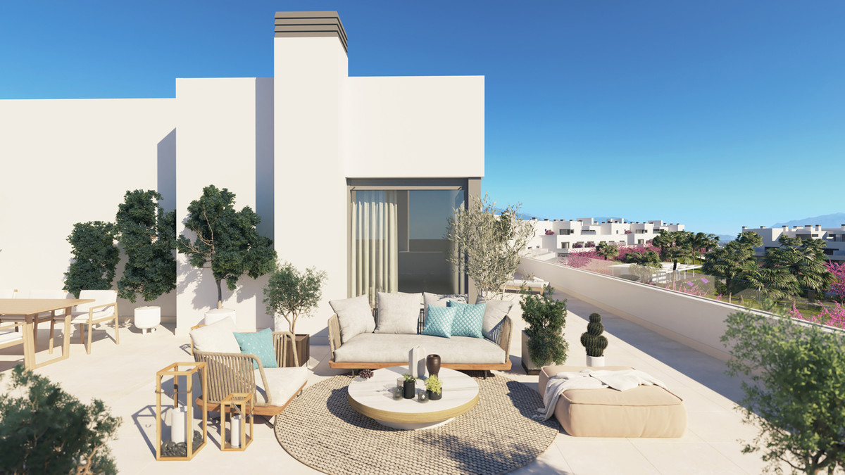 Acqua Gardens – Estepona - rooftop terrace with lounge seating, potted olive trees, and views over the surrounding residential community
