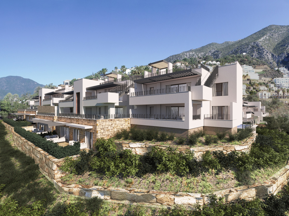 Almazara Forest + Gardens – Istán - terraced exterior facade with mountain backdrop and landscaped stone-walled gardens
