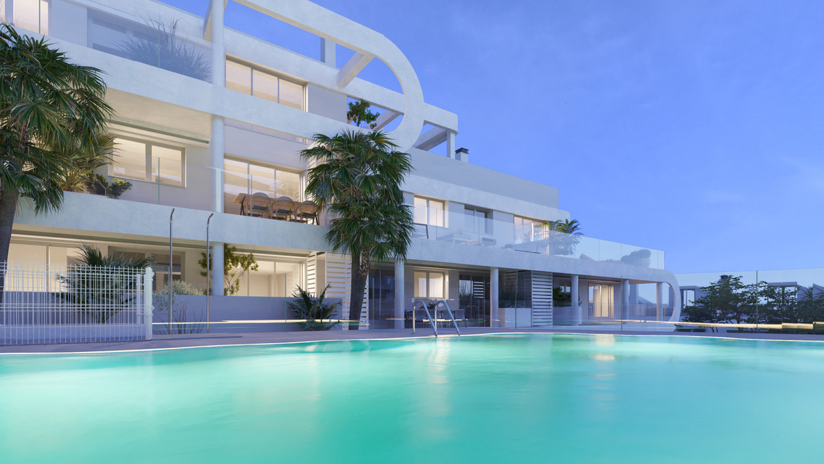 Anna De Estepona – Apartments – Estepona - modern white exterior facade with turquoise swimming pool and palm trees at dusk