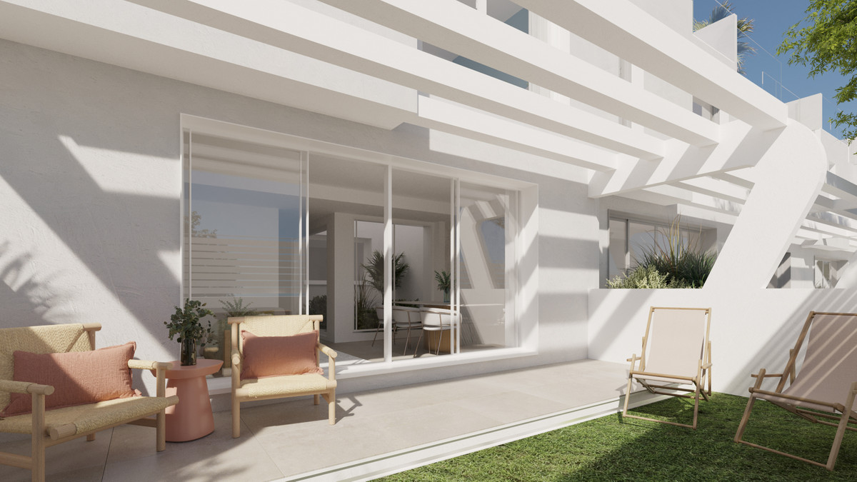 Anna De Estepona – Townhouses – Estepona - private ground-floor terrace with garden, lounge chairs and sliding glass doors