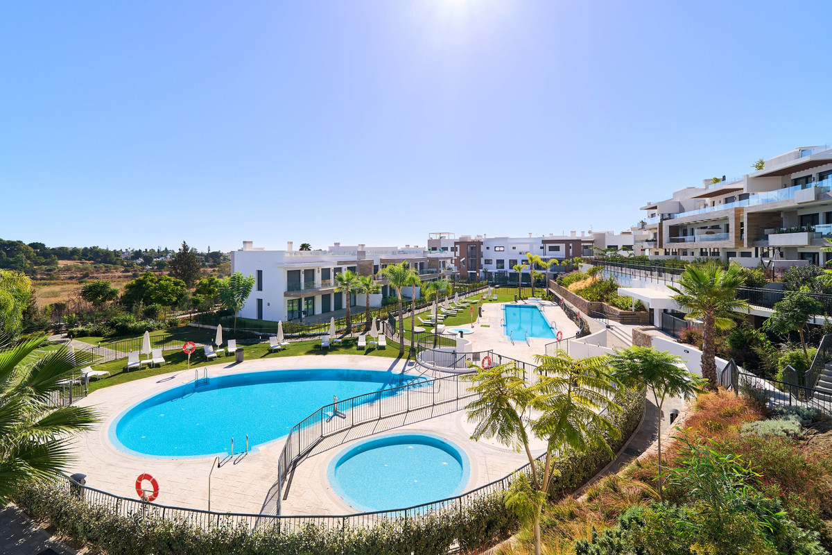 Atalaya Emotion – Estepona - aerial view of communal pools, landscaped gardens and modern white residential buildings