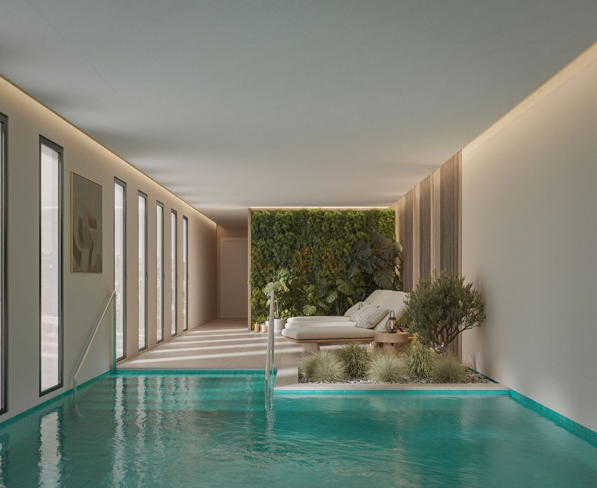 Balance Nova - Mijas indoor swimming pool with turquoise water, white sun loungers, and lush green living wall