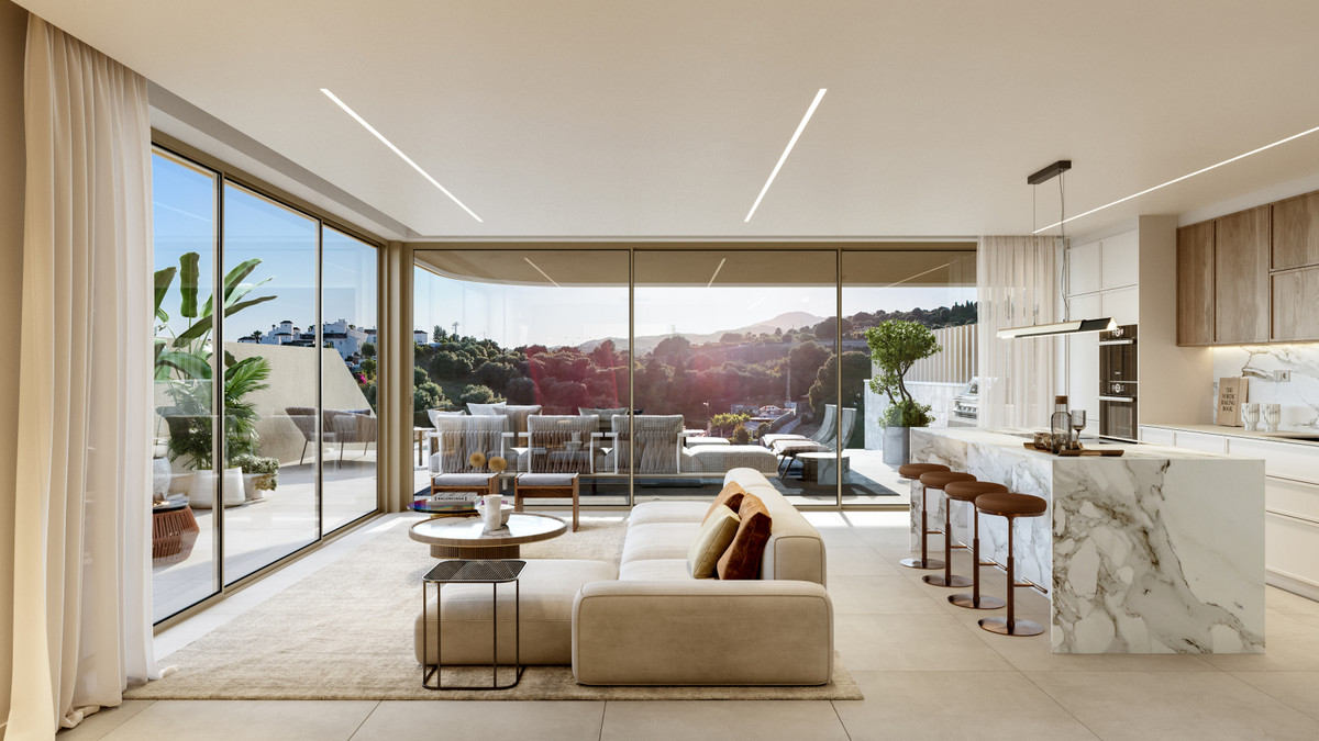 Beyond Homes – Estepona - offener Wohn- und Küchenbereich mit Marmorinsel und Panoramablick zur Terrasse