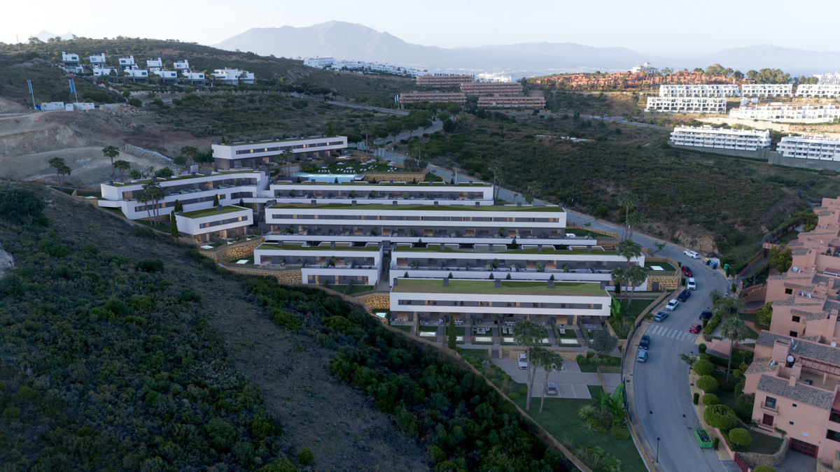 Blue Wave – Manilva - luchtfoto van getrapte witte moderne appartementen op een heuvel met zwembad en groene daken
