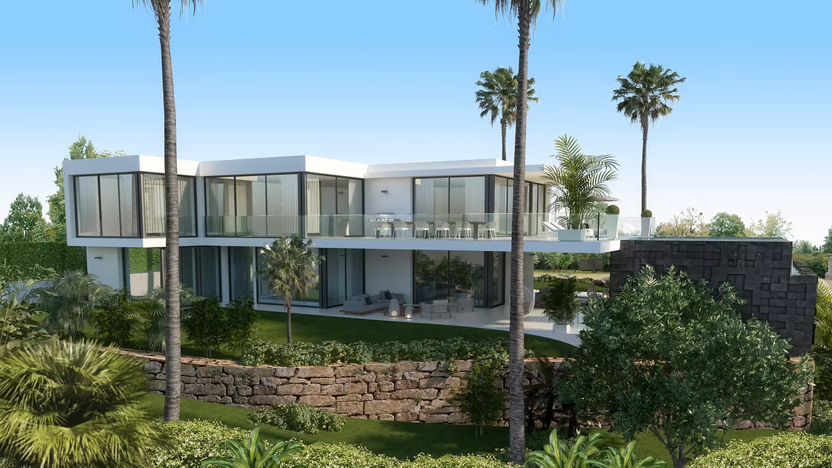 Cabopino Gardens – Villa 11 – Cabopino - modern white exterior facade with glass walls, terraces, palm trees and landscaped gardens