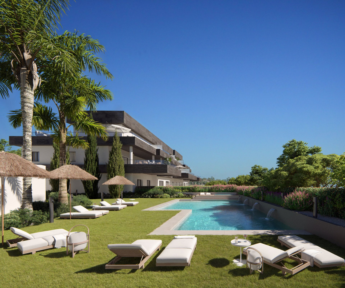 Casares Bay – Casares - luxury outdoor pool and sun terrace with palm trees and modern residential building