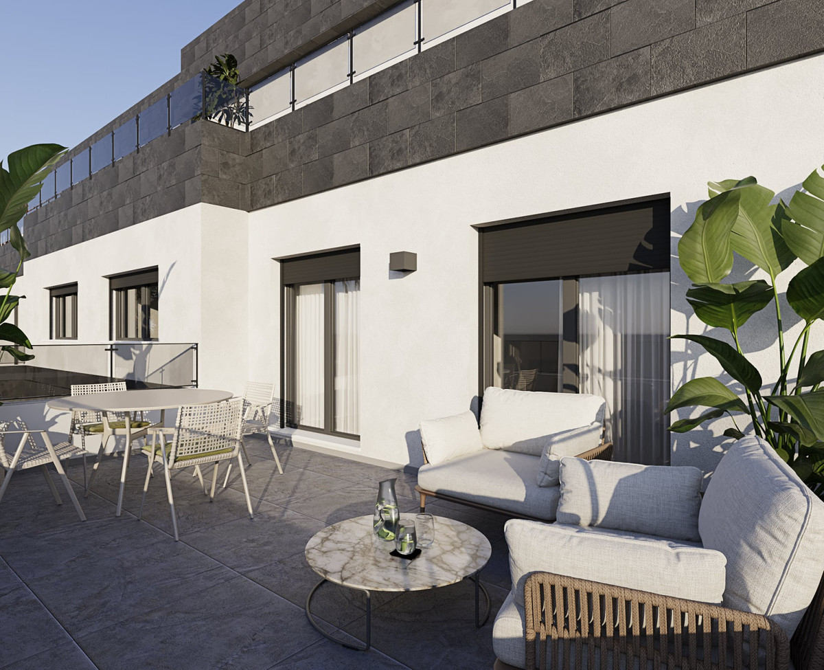 Casares Bay – Casares - sunny terrace with lounge seating, marble coffee table and tropical plants on a new-build residential building
