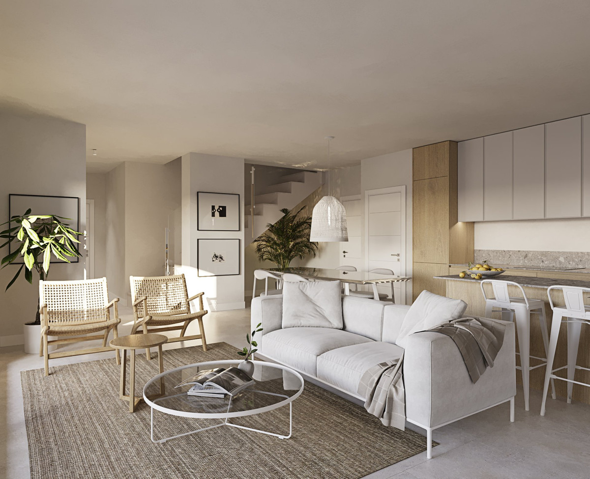 Casares Bay – Casares - bright open-plan living and dining area with white sofa, rattan chairs, and modern kitchen