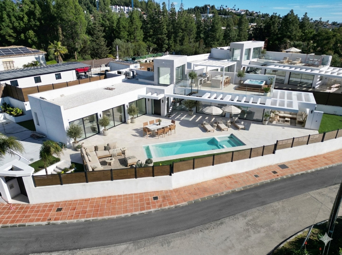 Chaparral Sunset Villas – El Chaparral - aerial view of modern white villa with outdoor pool, terrace, and sun loungers