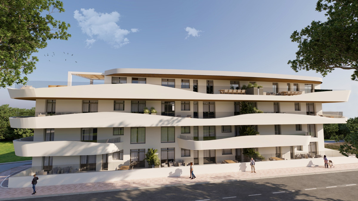 Green Mountain 1 – Estepona - exterior facade of modern white curved apartment building with terraces