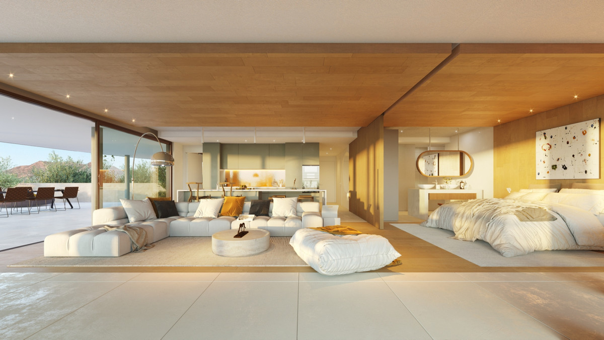 Higueron South Residences – Fuengirola - åbent living med sofa, køkken, soveområde og loft i træ