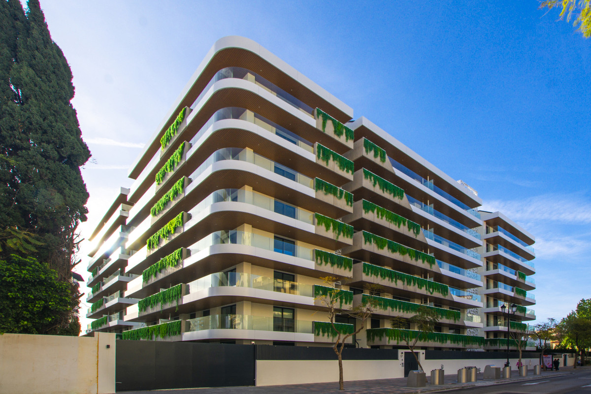 Jade Tower with Furniture – Fuengirola - modern luxury apartment exterior facade with cascading green balcony plants, Fuengirola