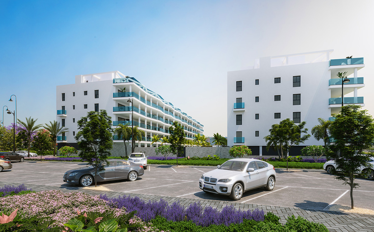 Jardines de Las Lagunas Fase II – Las Lagunas - exterior facade of white modern apartment buildings with teal balconies and landscaped parking area
