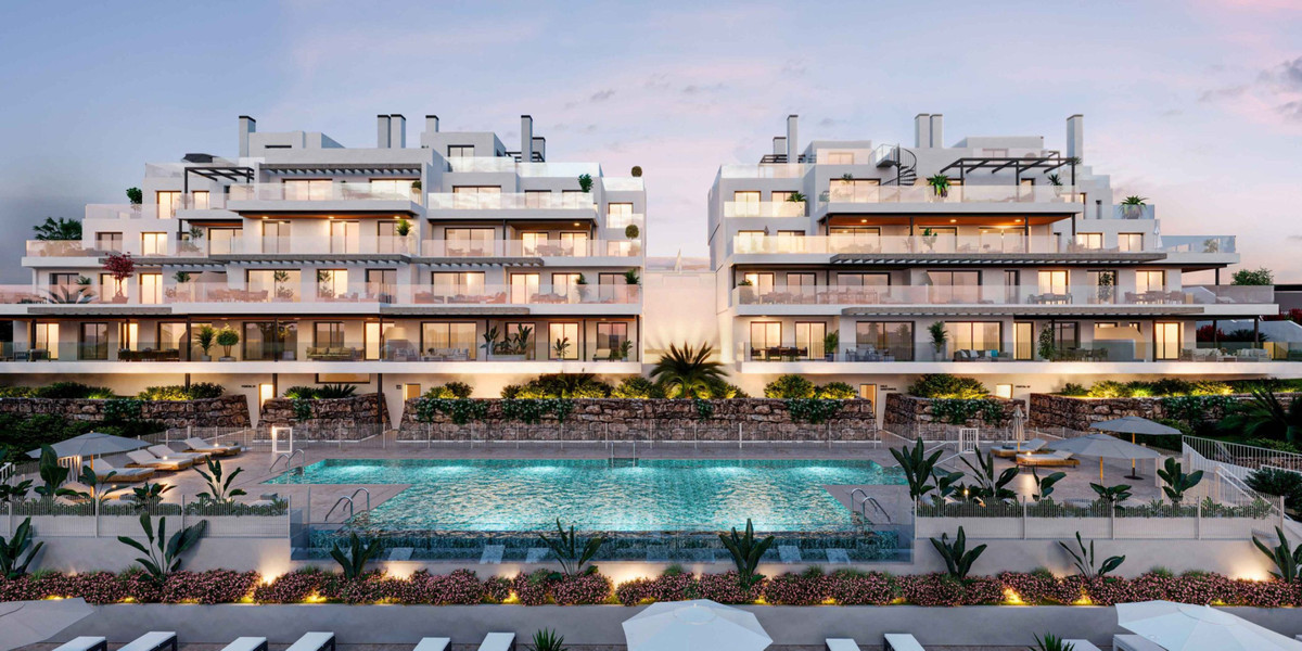 Las Mesas Collection – Estepona - luxury residential complex exterior with illuminated communal pool and landscaped terraces at dusk