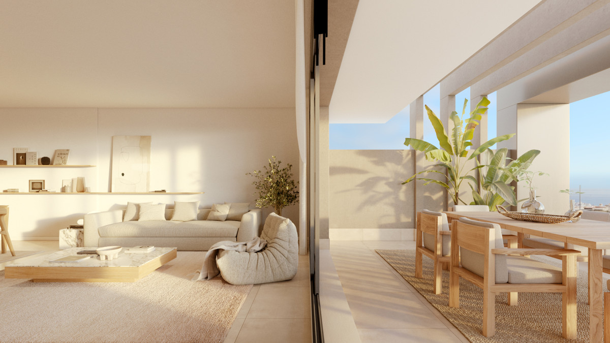 Las Mesas Infinity Homes – Estepona - bright open-plan living room flowing onto a sunny terrace with dining area and tropical plants
