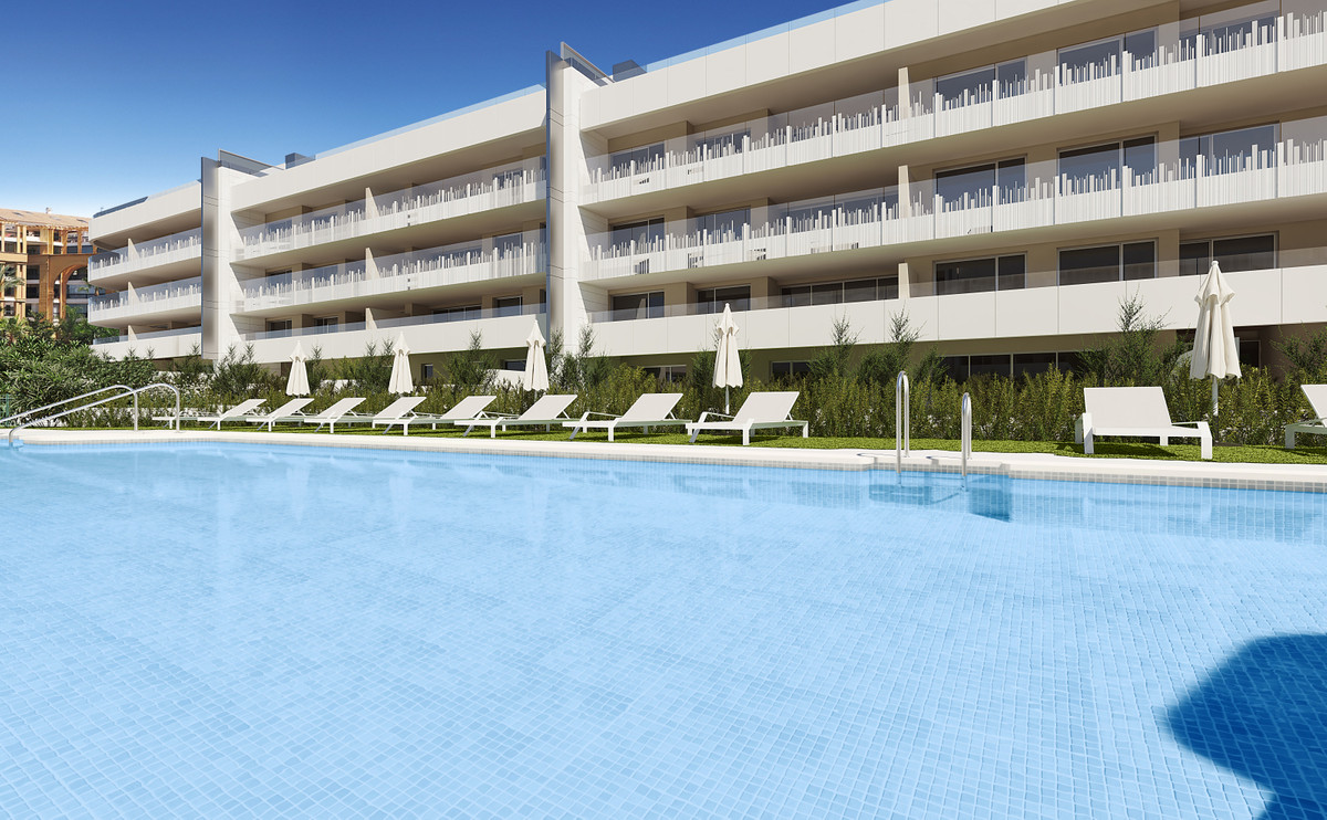 Mare – San Pedro de Alcántara - modern apartment complex exterior with large communal swimming pool and white sun loungers