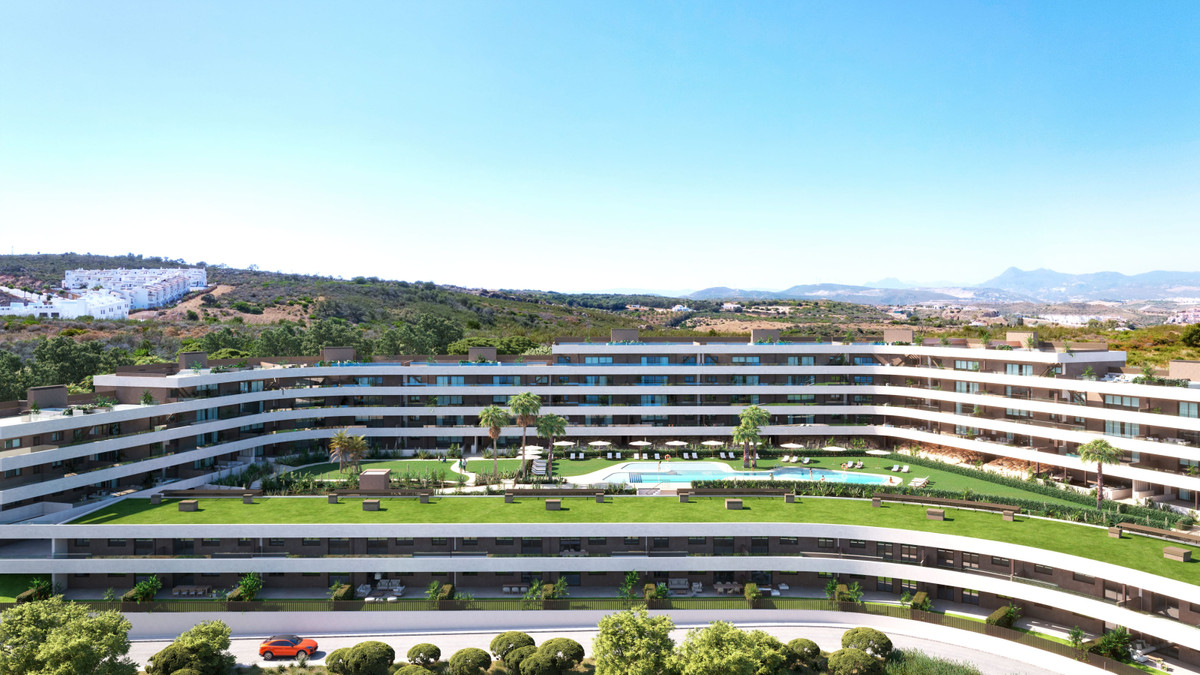 Morasol – Builiding 2 – Manilva - curved luxury residential complex with communal pool, manicured lawns, and mountain backdrop