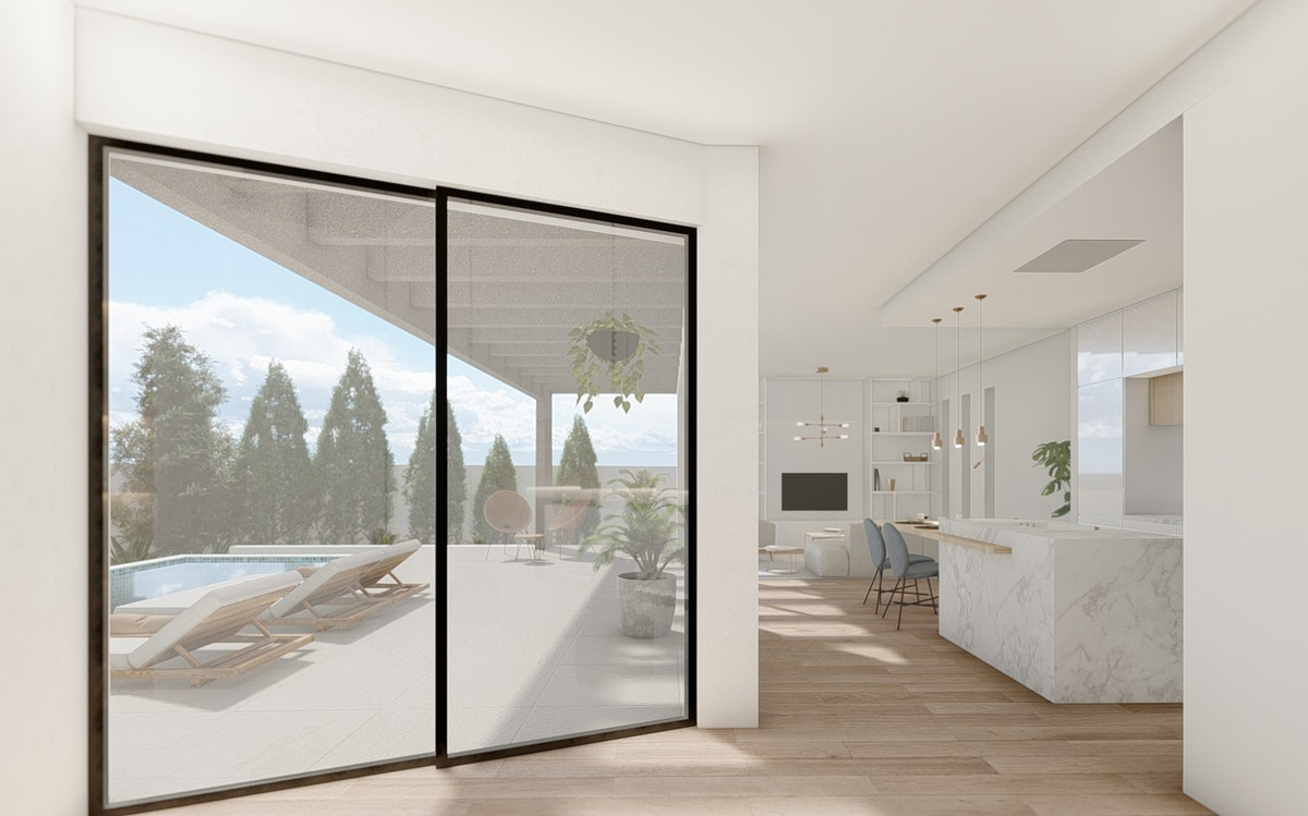 Nordic – Benalmadena Costa - open woonruimte met marmeren keukeneiland, schuifpuien en uitzicht op het zwembadterras