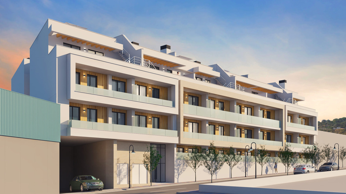 Residencial Mijasol – Las Lagunas - moderne nieuwbouw appartementgevel met glazen balkons en daktuinen in de schemering