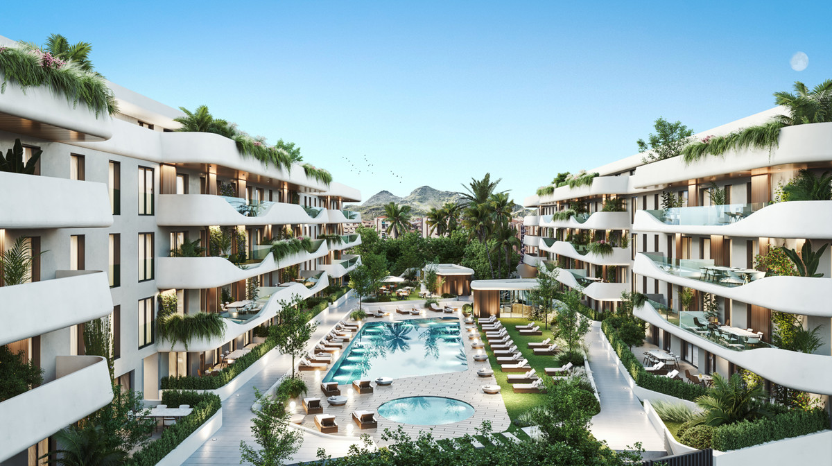Salvia II – San Pedro de Alcántara - aerial view of luxury residential courtyard with large pool, sun loungers, tropical gardens and white curved balconies