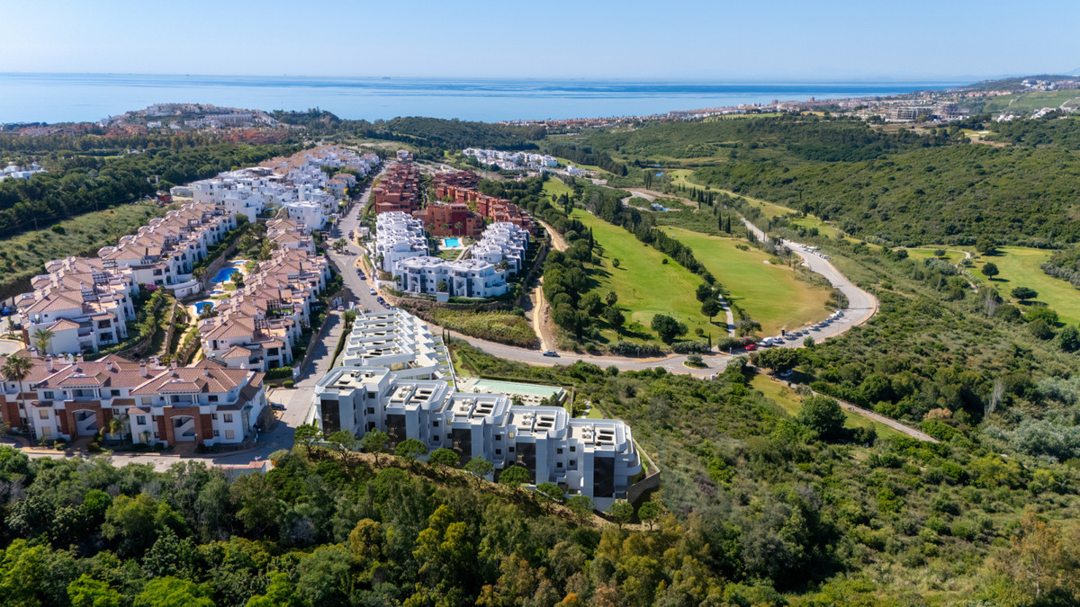 Skye Casares Golf – Casares - aerial view of luxury new-build development surrounded by golf course, lush hills and Mediterranean Sea