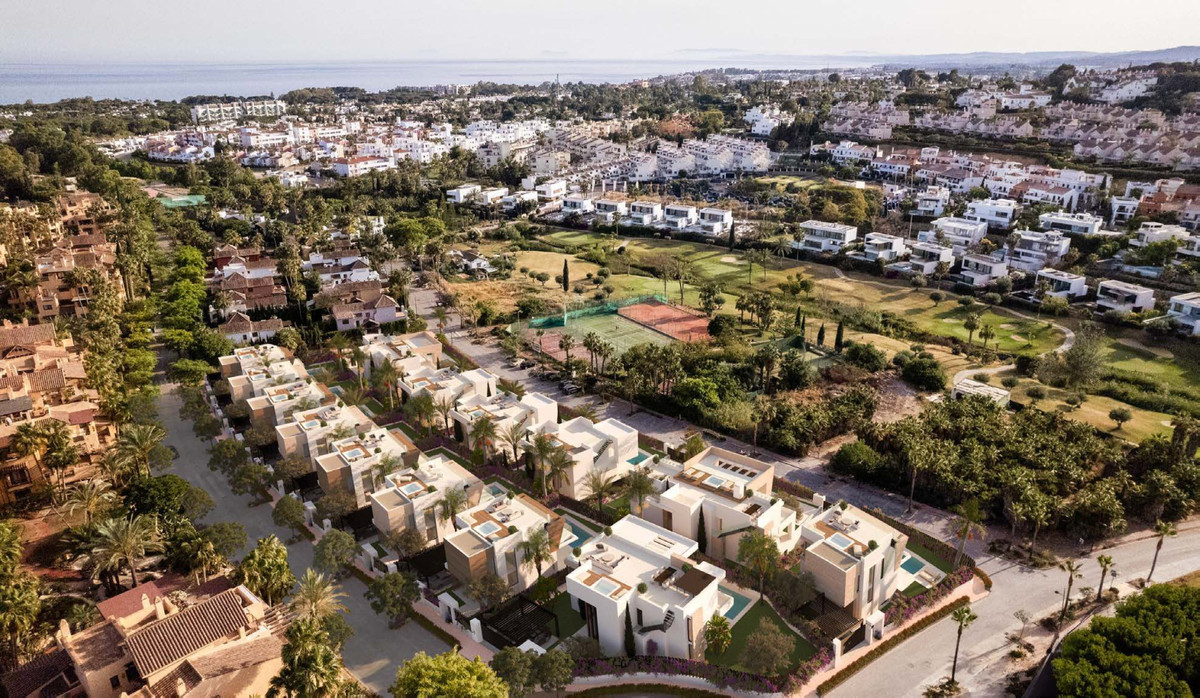 The Club Villas – Estepona - aerial view of luxury new-build villa development surrounded by golf course, palm trees and Mediterranean Sea backdrop