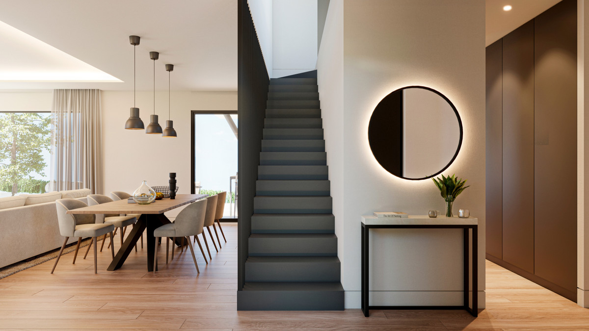 Villa Aitana – Mijas - modern open-plan living area with dark staircase, dining table and backlit circular mirror in hallway