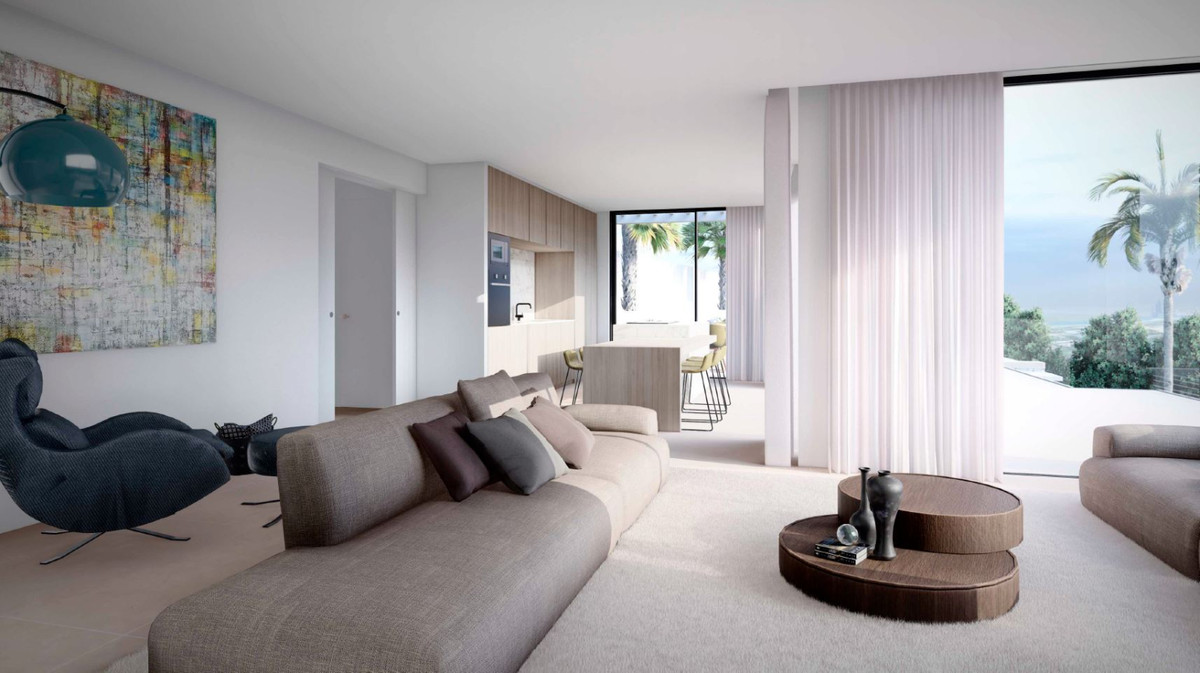 Villa Ana – Artola – offener Wohnbereich mit geschwungenem Sofa, Stufentisch und Panoramablick auf Meer und Palmen