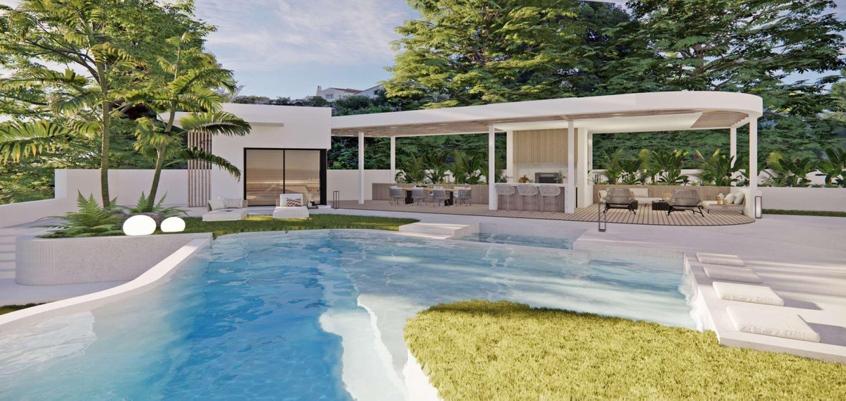 Villa Flores 11 – Rancho Santa Mónica – Benalmadena - witte pergola met buiteneethoek, lounge en vrijvormbad in weelderige tuin