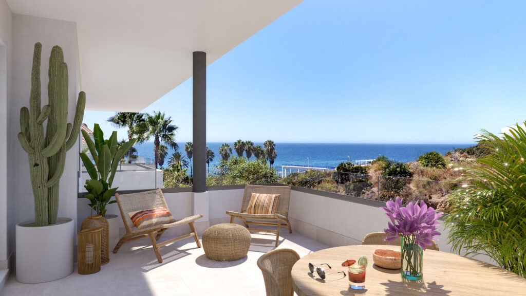 Vitta Marina – La Cala de Mijas - sunny terrace with rattan chairs, cactus, and panoramic sea views over lush greenery