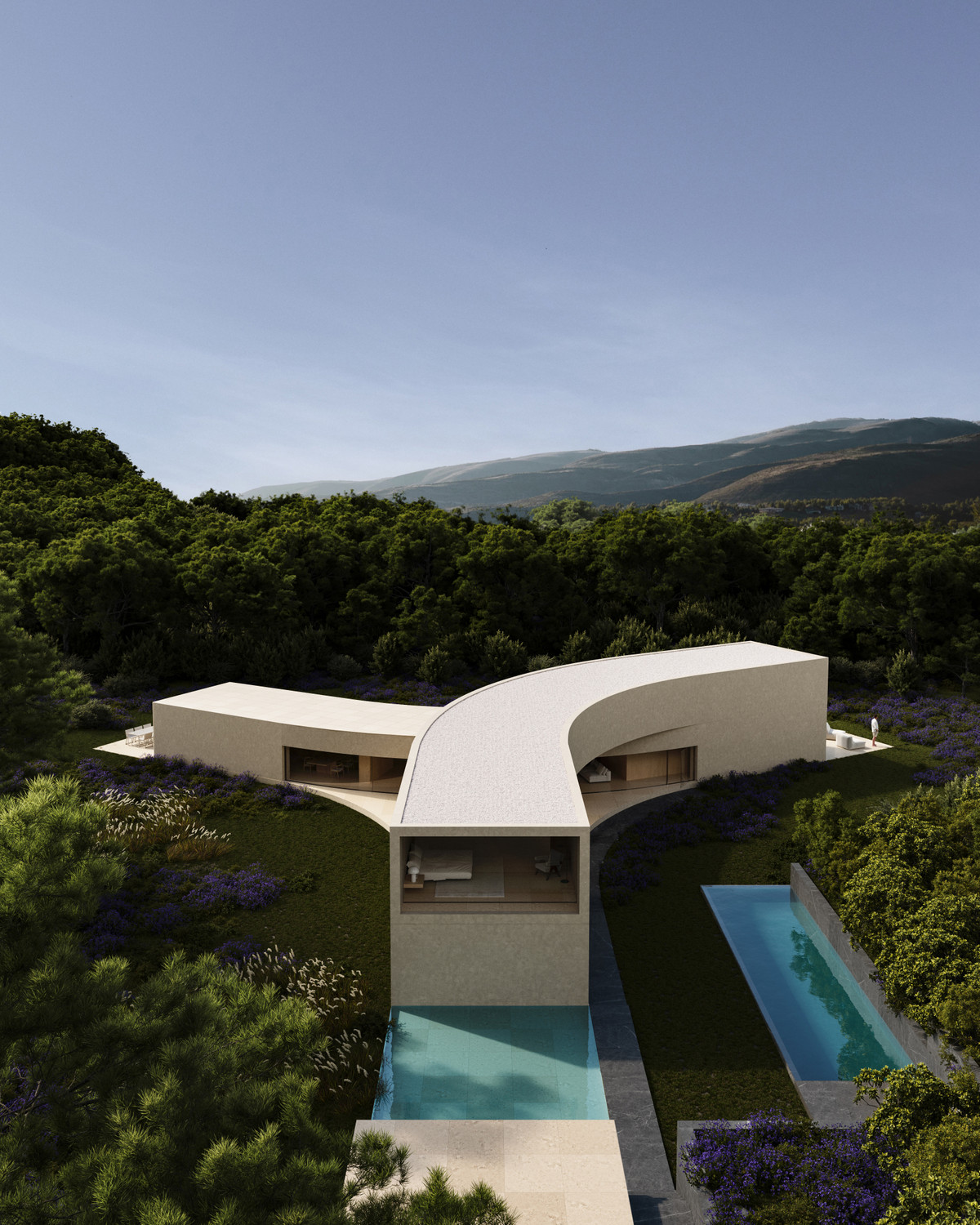Villa STERN – San Roque - aerial view of curved white villa with infinity pool and lavender gardens amid forested hillside