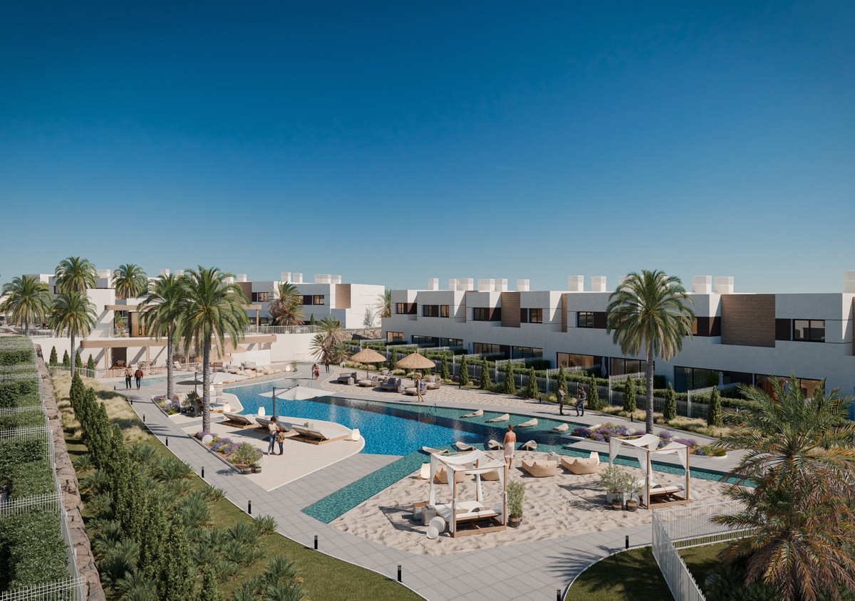 Savia – Fase 2 – Mijas - gemeenschappelijk zwembad met zandig chill-outgebied, ligstoelen, palmbomen en moderne witte rijwoningen