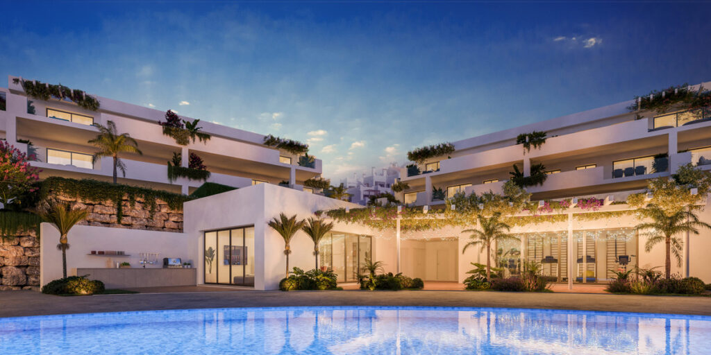 Amaranta Living – Casares - luxury exterior with illuminated pool, lush terraces and modern facade at dusk