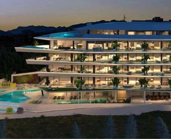 Carat Fase II – Fuengirola - illuminated luxury residential facade with pool and terraces at dusk