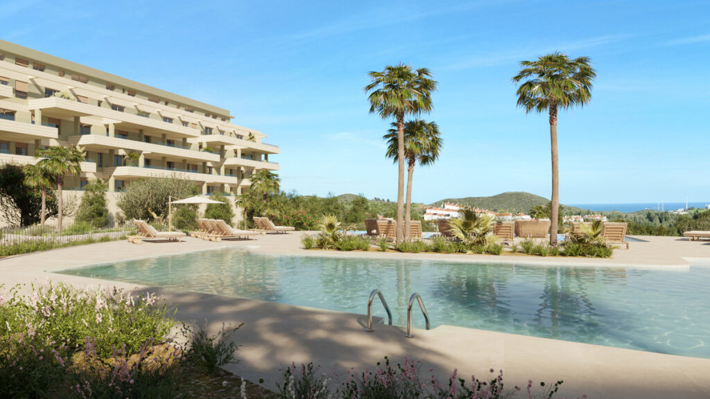 Greenity – Mijas - luxury outdoor pool with palm trees, sun loungers and modern residential building on the Costa del Sol