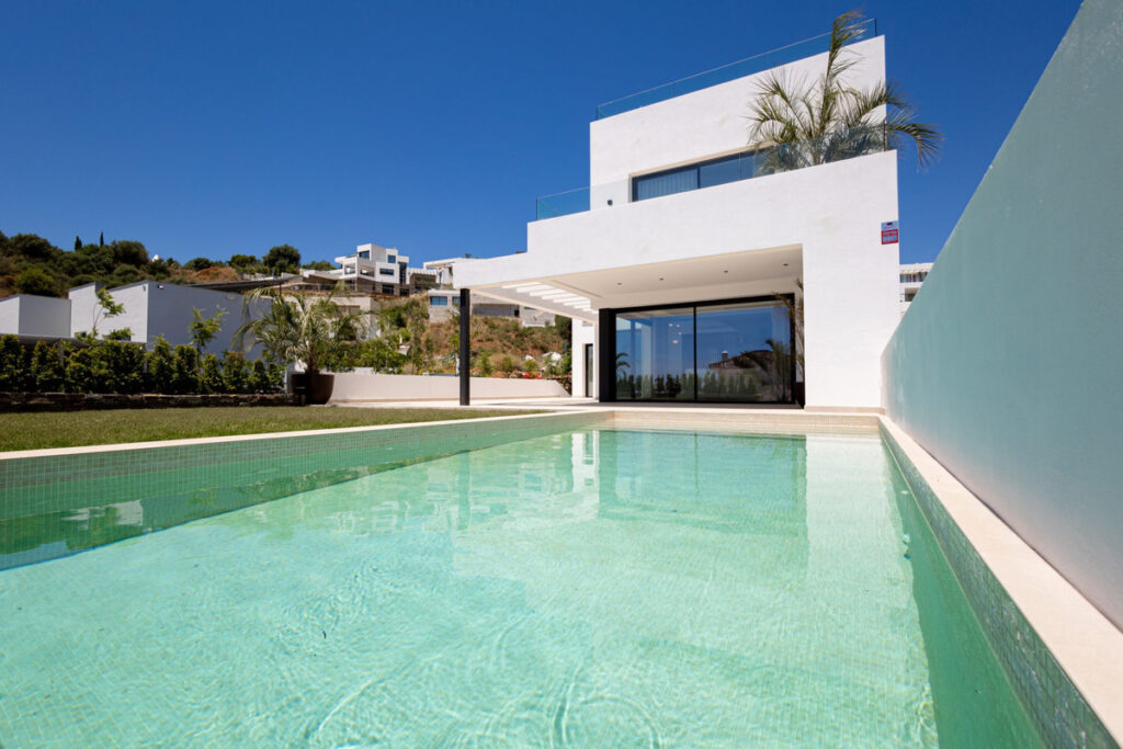 Higueron Hills Collection – Mijas - modern white villa exterior with turquoise swimming pool and glass sliding doors