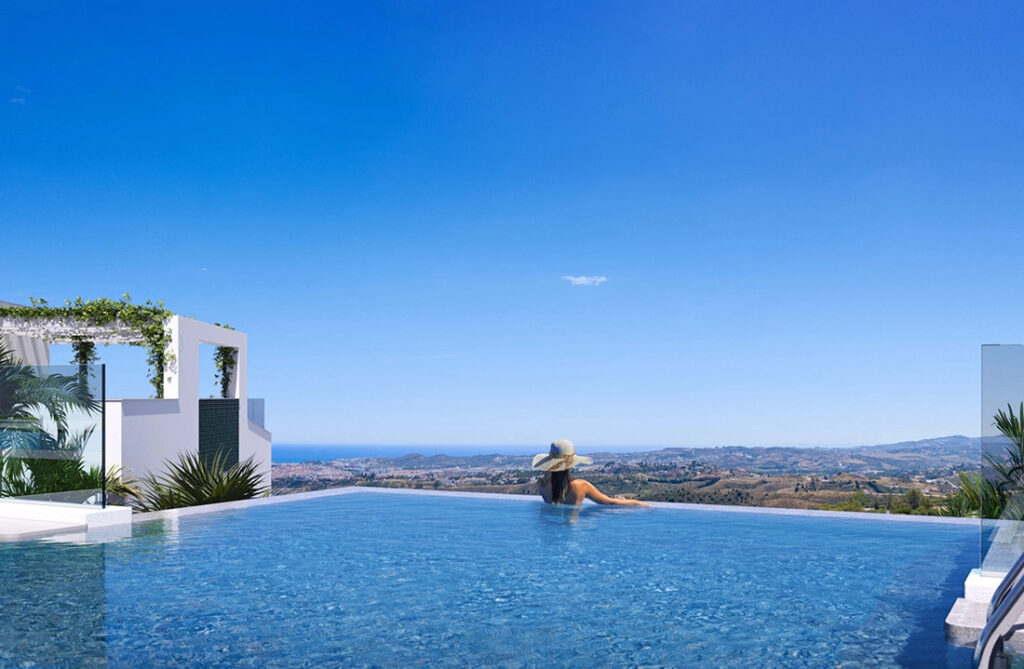 Mijas Seaviews FASE II – Mijas - woman in infinity pool with panoramic sea and valley views under a clear blue sky