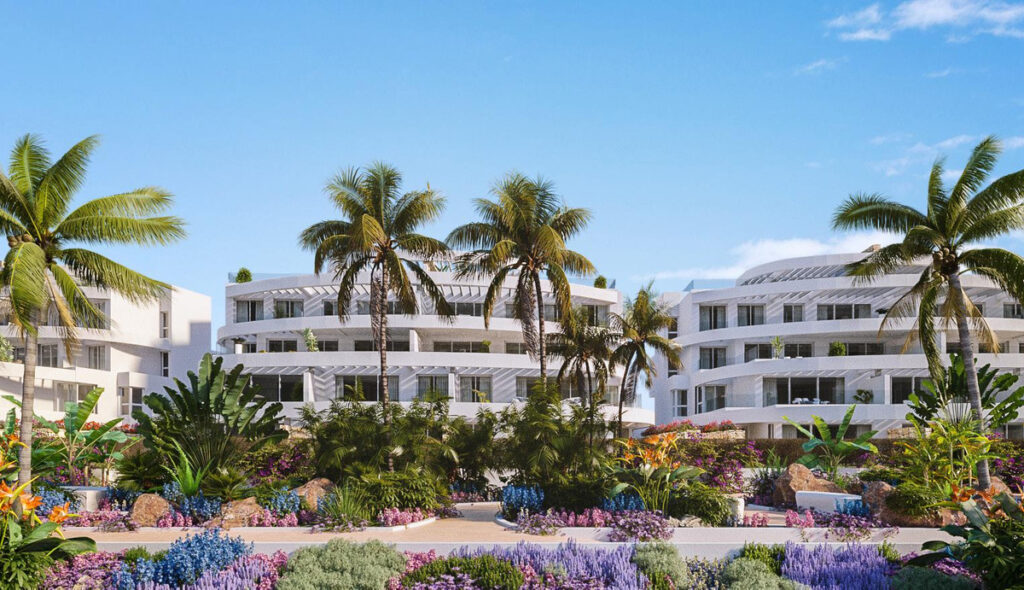 Royal Palms Mijas – FASE IV-2 – La Cala de Mijas - white curved apartment complex surrounded by palm trees and colourful Mediterranean gardens