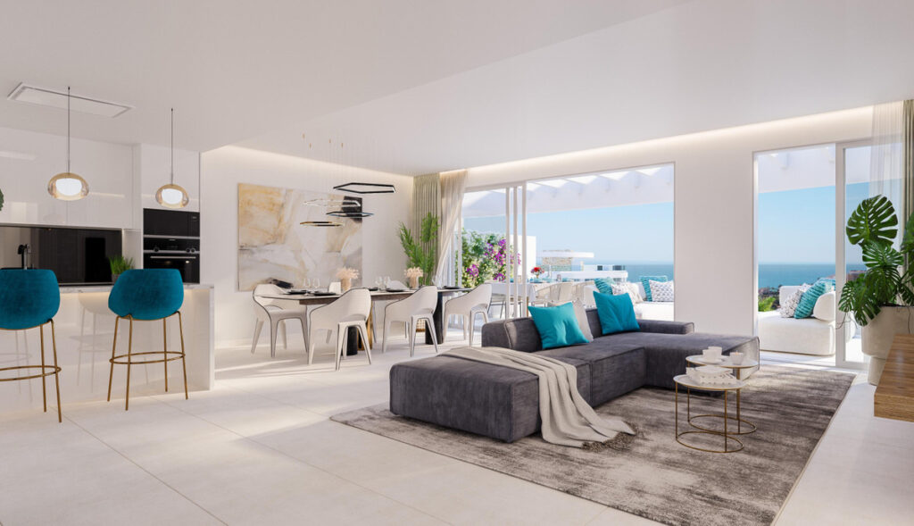Royal Palms Mijas – FASE IV-2 – La Cala de Mijas - open-plan living room with grey sectional sofa, teal cushions and panoramic sea views