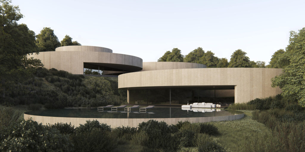 Villa NOON – San Roque - curved travertine exterior with circular infinity pool surrounded by lush greenery