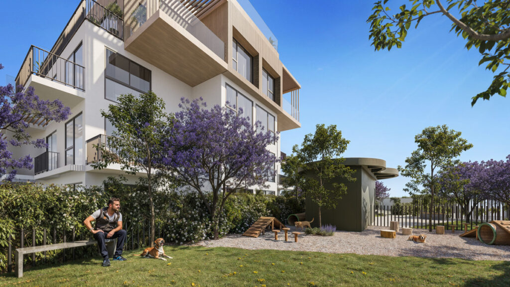 Ykines – Torremolinos - landscaped garden and dog park area with jacaranda trees beside modern residential building