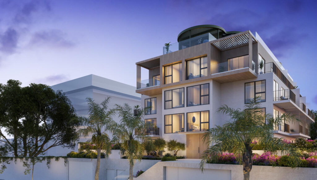 Ykines – Torremolinos - modern luxury apartment building exterior at dusk with illuminated balconies and rooftop terrace