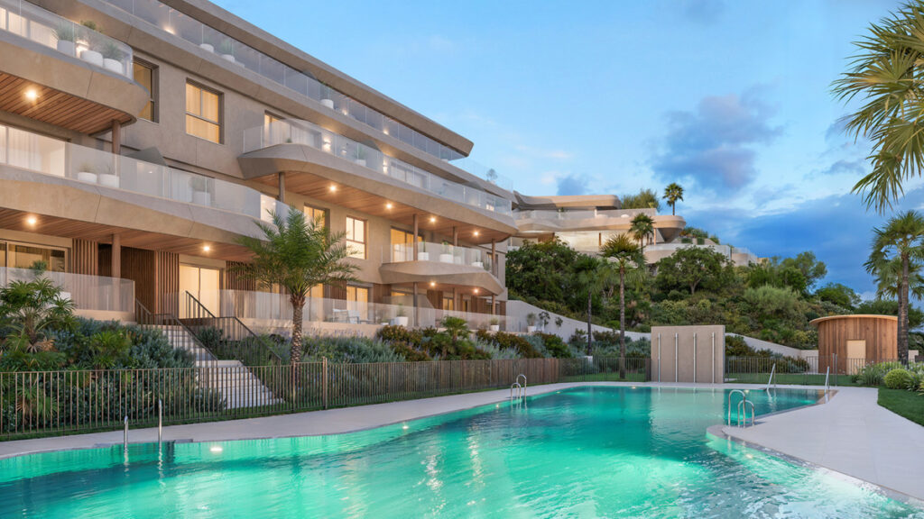 VISSION HILLS II – La Cala de Mijas - luxury residential complex with illuminated pool and terraced apartments at dusk