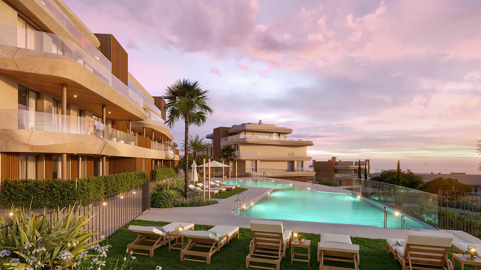 Vission Hills illuminated pool with sun loungers at sunset and sea views beyond
