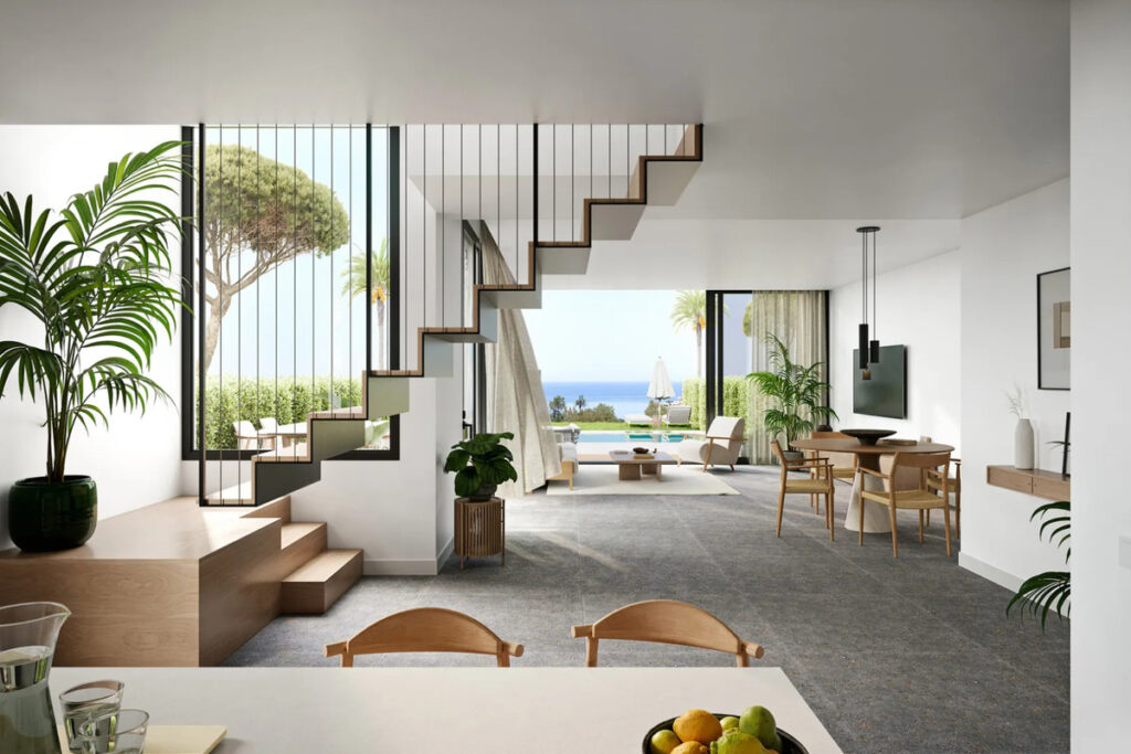 PINE VALLEY VILLAS FASE III – Mijas - open-plan living and dining area with floating staircase, tropical plants, and sea views